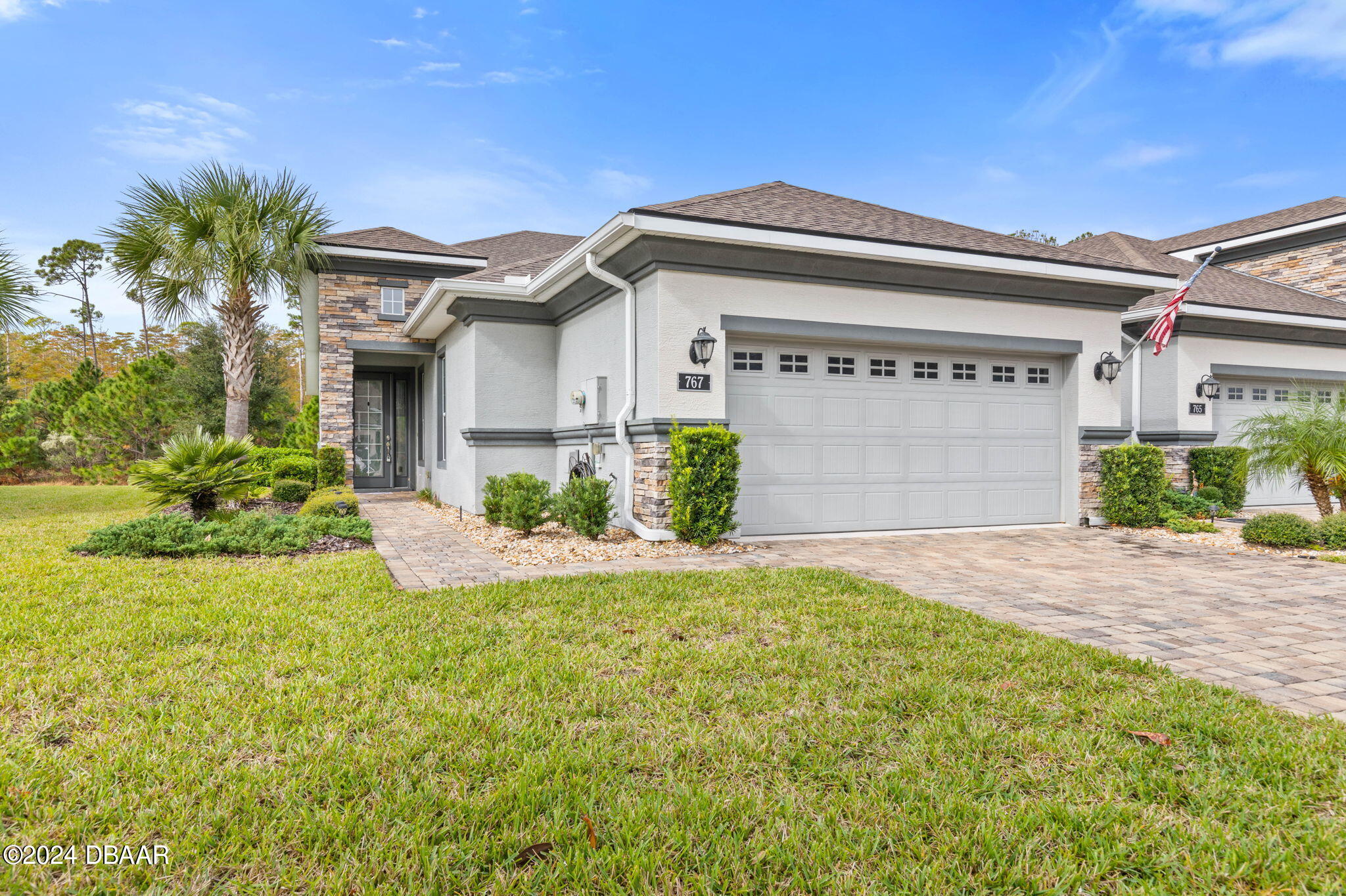 a front view of a house with a yard and garage