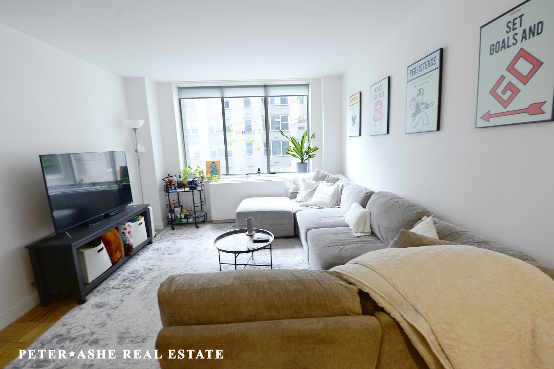 a living room with furniture and a flat screen tv