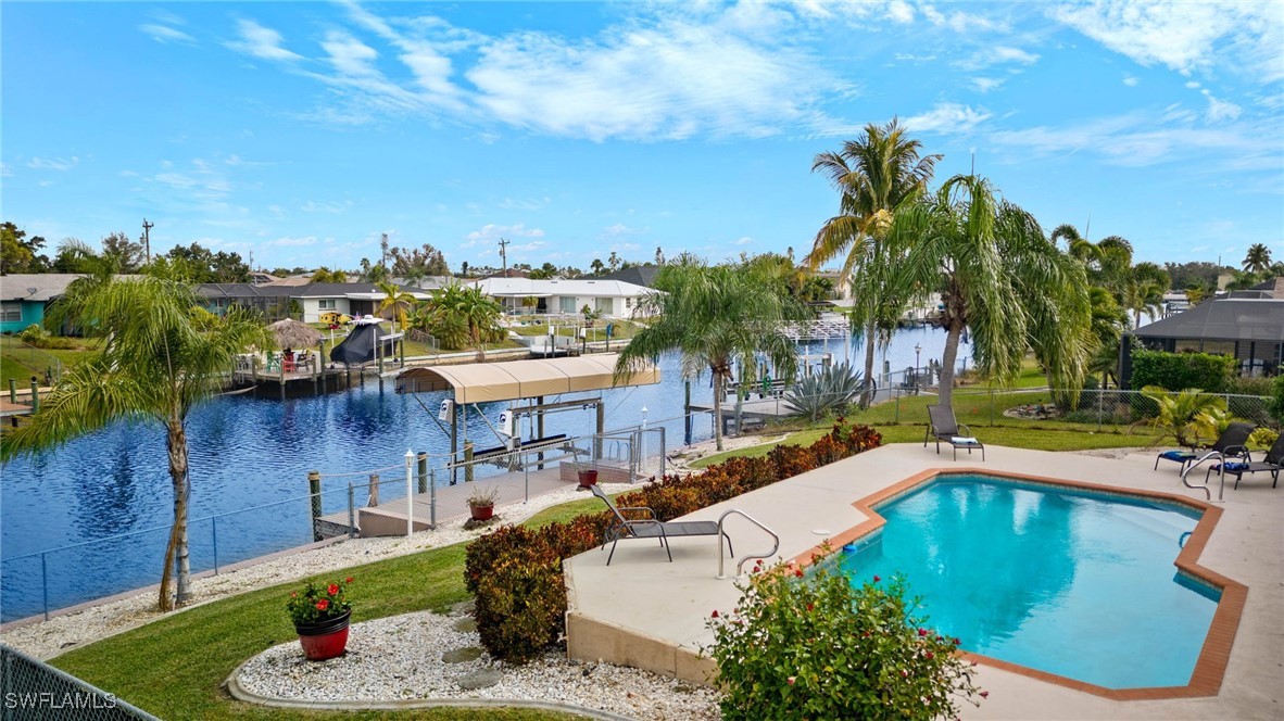 a swimming pool with outdoor seating and yard