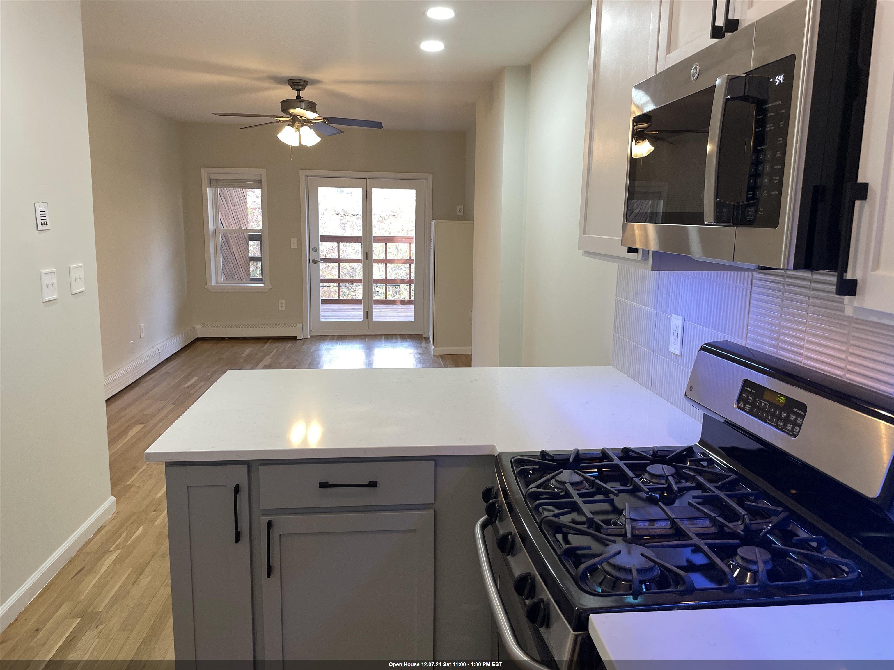 a kitchen with a stove a sink and a window