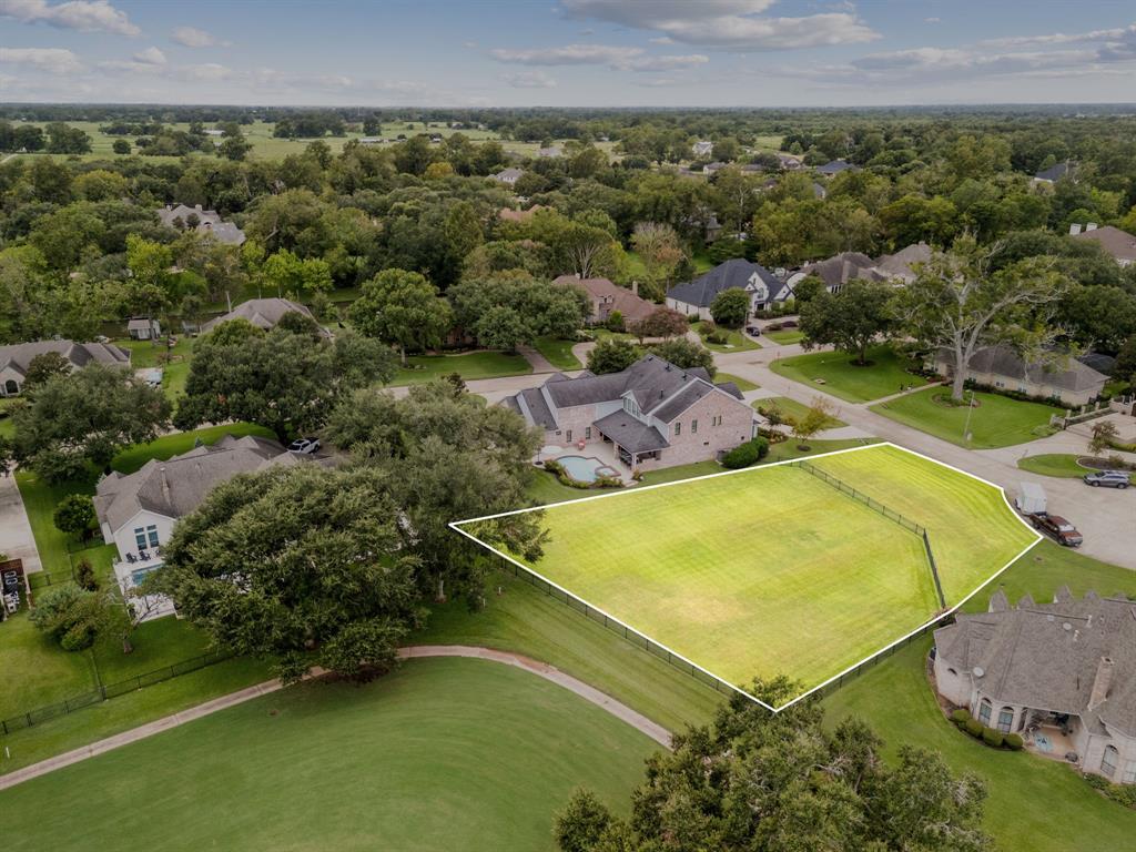 an aerial view of residential houses with outdoor space and swimming pool