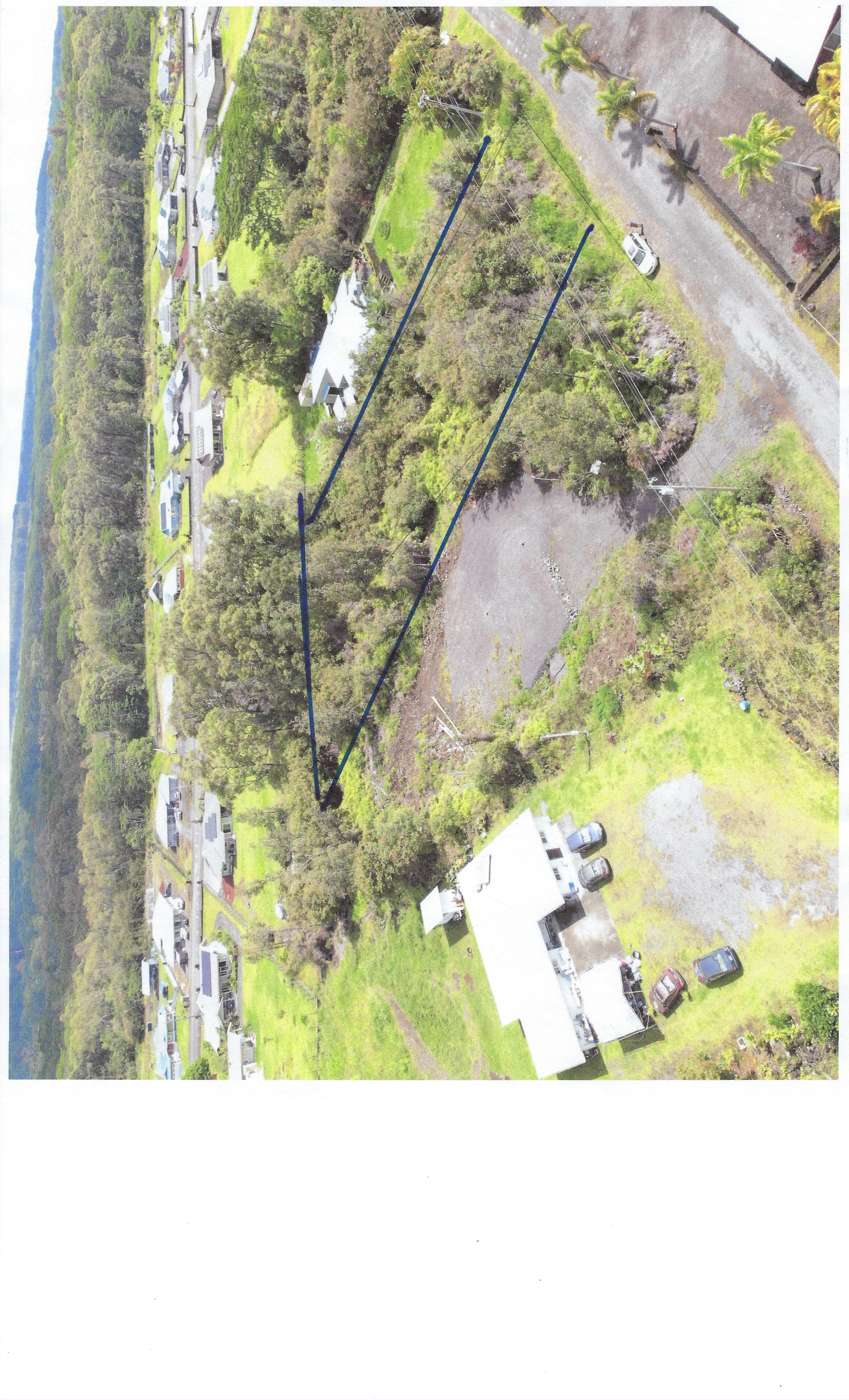 Vacant lot between two homes and a cleared lot.