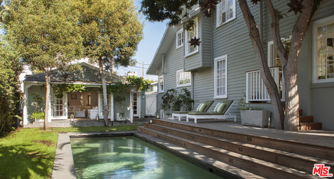 a view of a house with swimming pool and sitting area