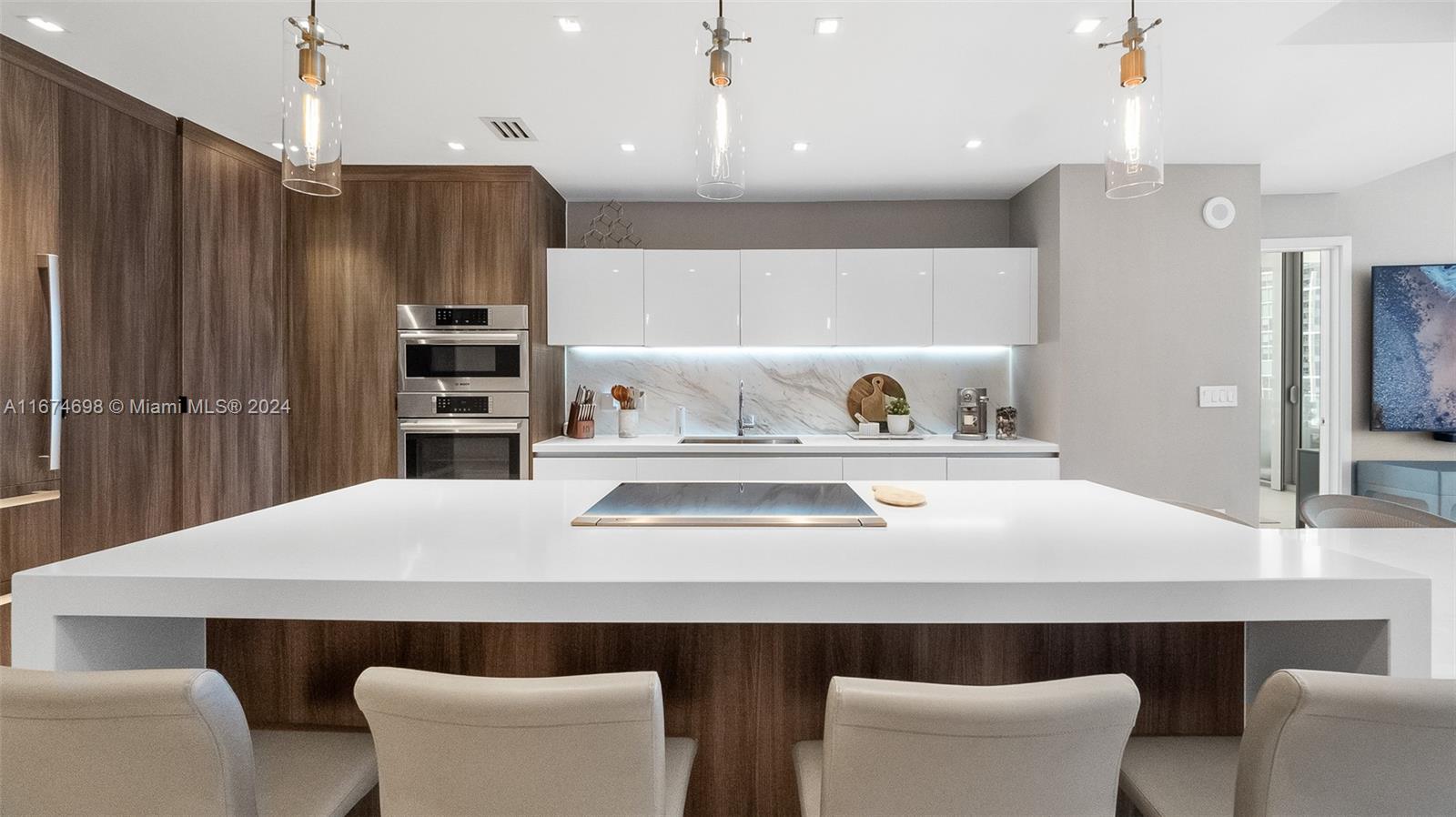 a kitchen with a table chairs refrigerator and microwave