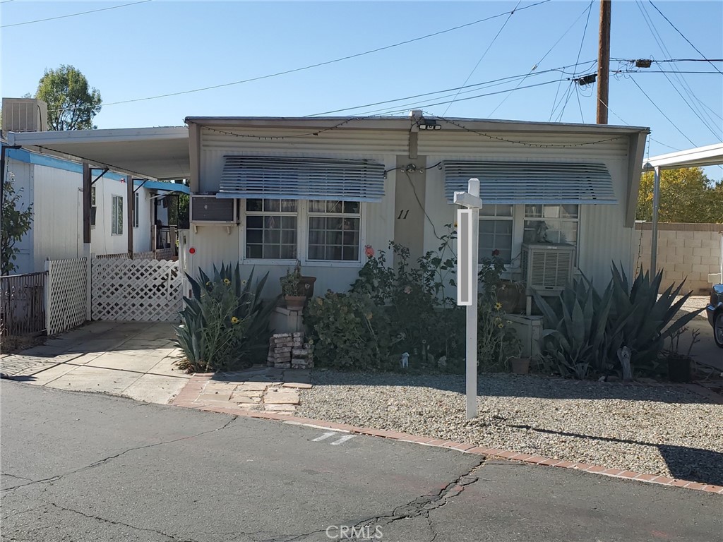 a view of a house with potted plants and a window