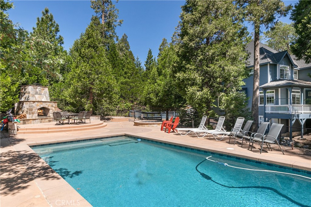 a view of a house with swimming pool and sitting area