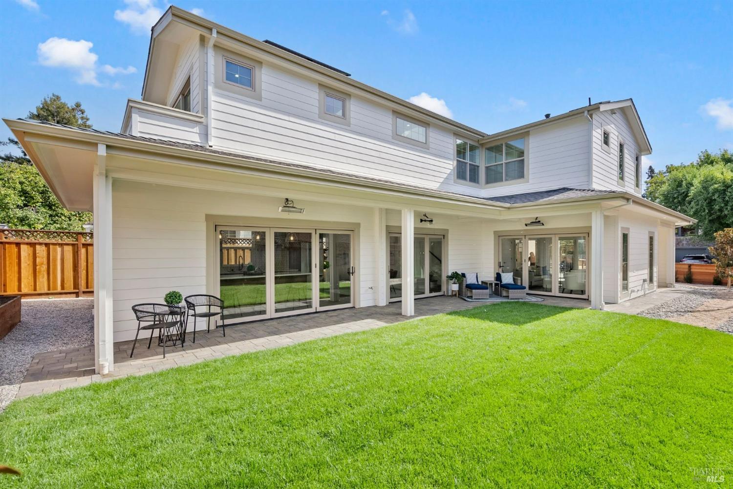 a view of a house with a yard and sitting area