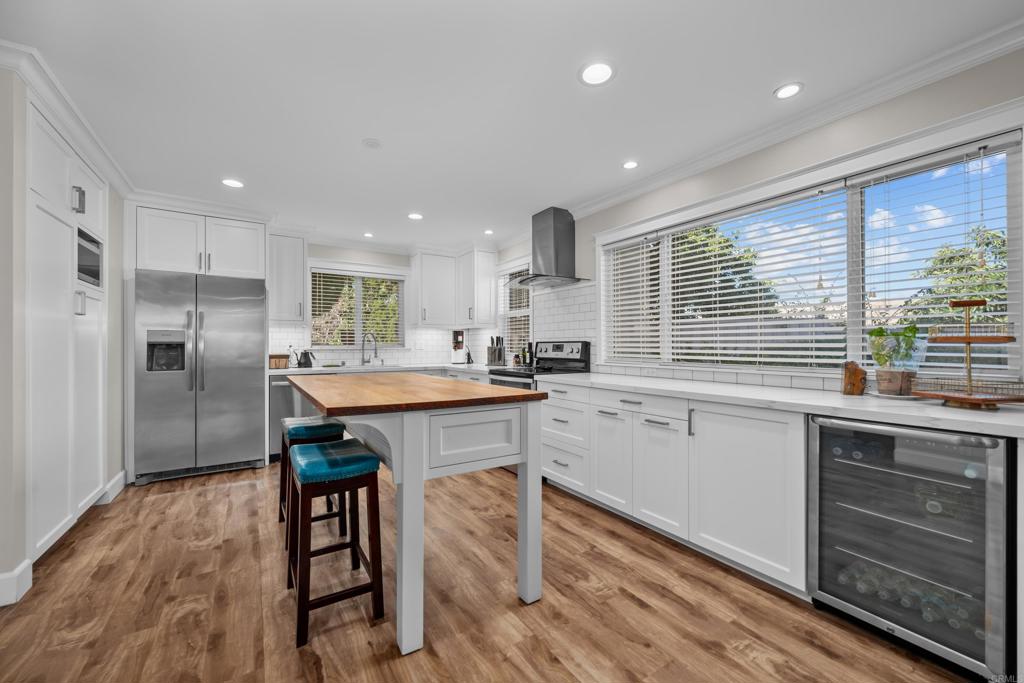 a kitchen with a sink appliances and cabinets