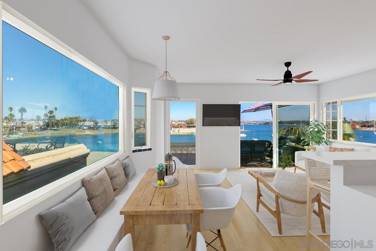 a living room with furniture kitchen view and a large window