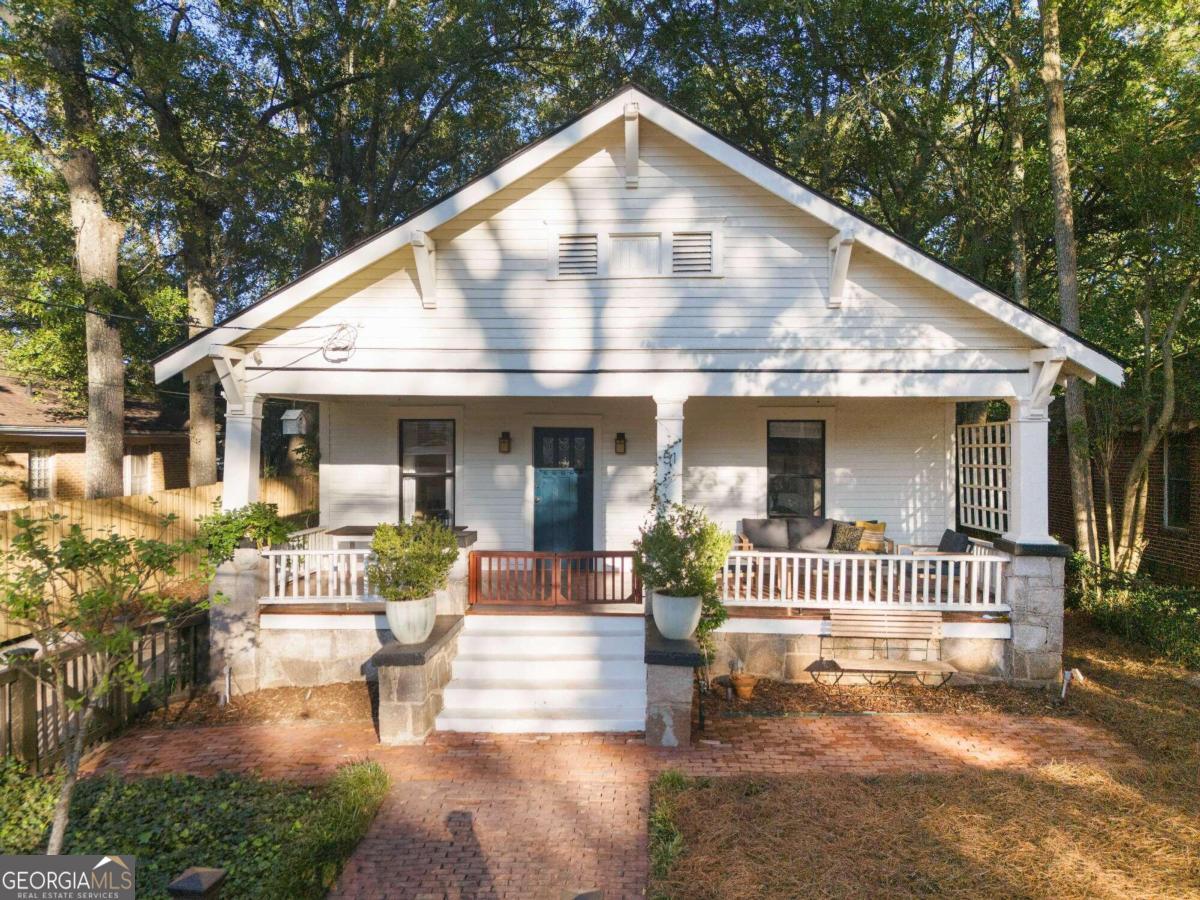 a front view of a house with a garden and porch