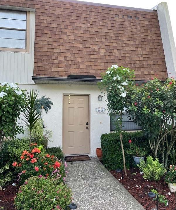 a front view of a house with plants