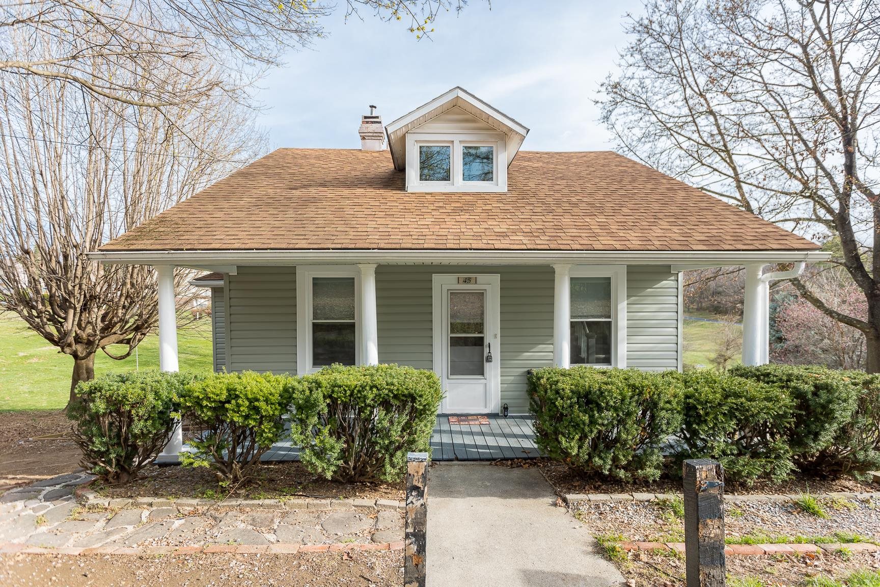 a front view of a house with garden