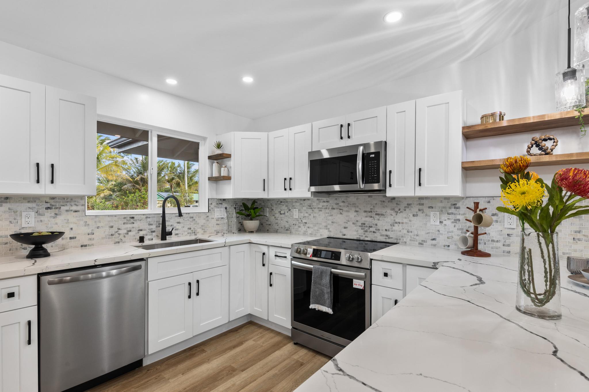 a kitchen with a sink stove and microwave