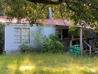 a backyard of a house with yard table and chairs