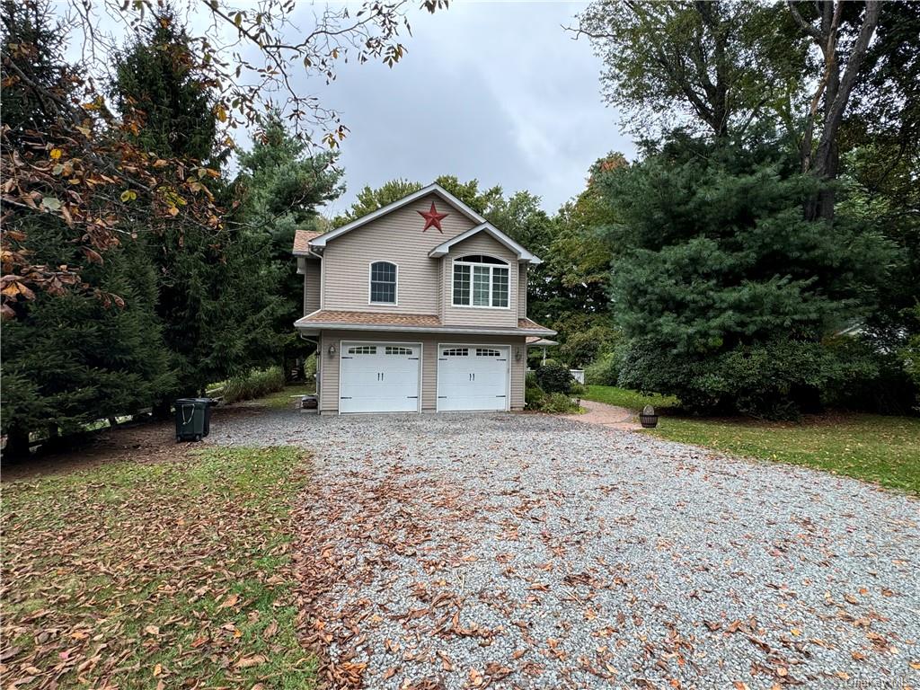 View of property exterior with a garage