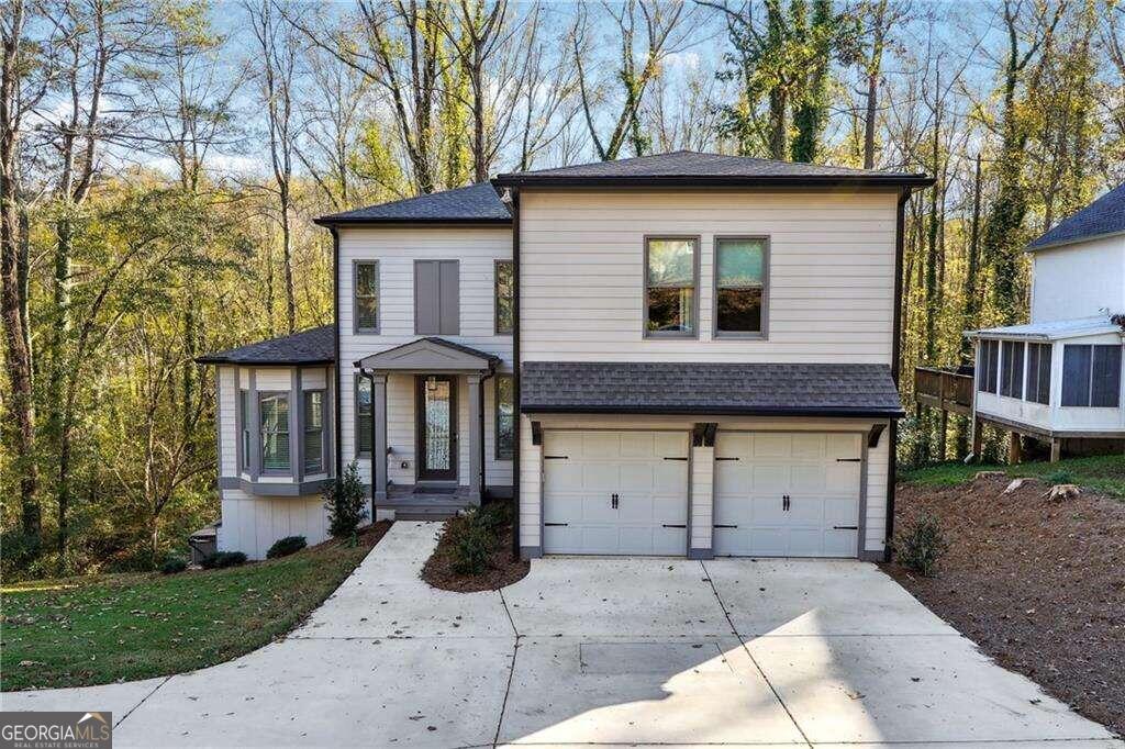 a front view of a house with a yard and garage