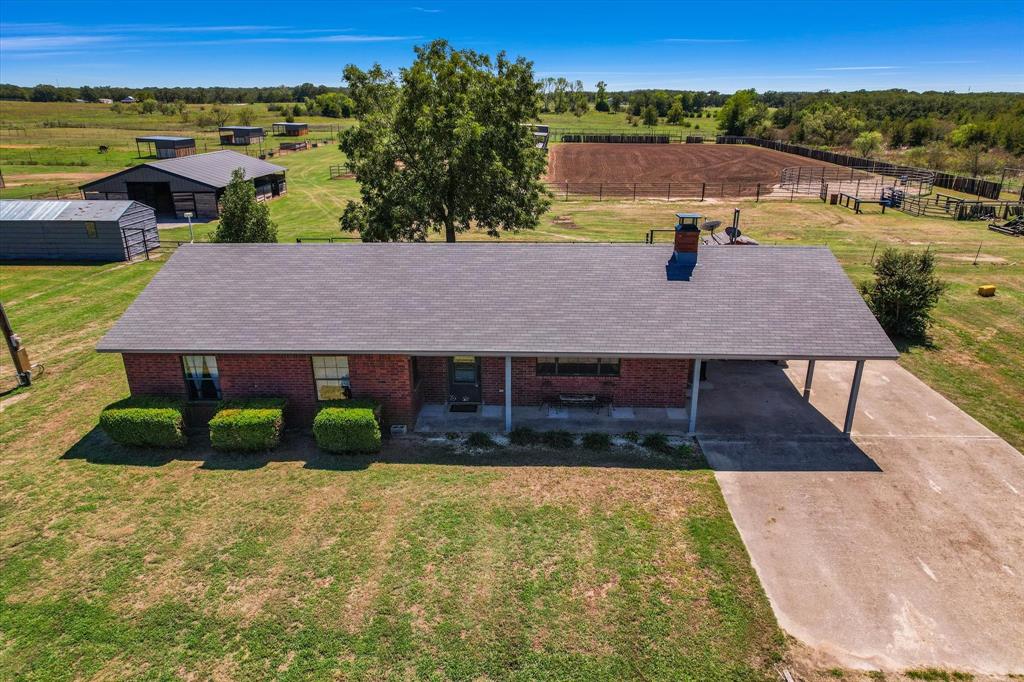 aerial view of a house with a yard