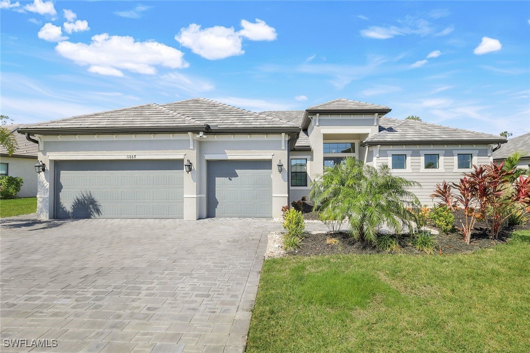 a front view of a house with a yard and garage