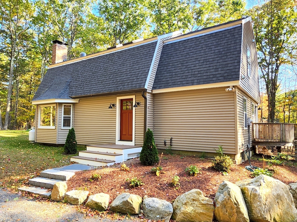 a front view of a house with a garden