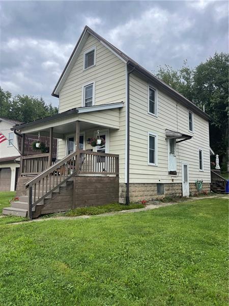 a front view of house with yard and green space