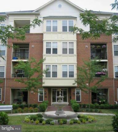 a front view of a residential apartment building with a yard