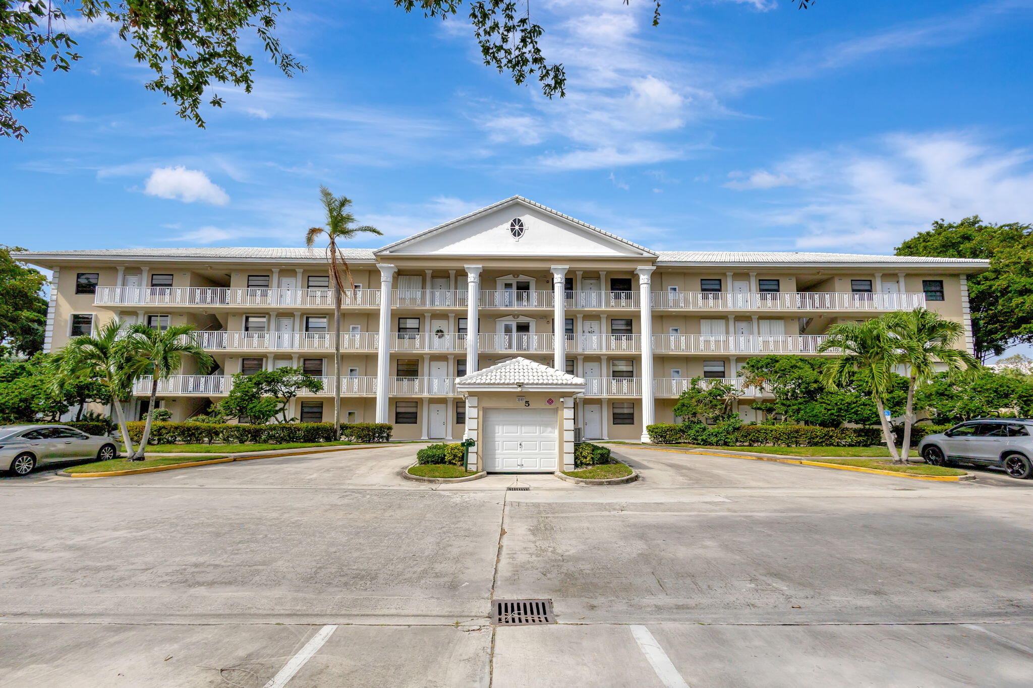 a front view of a building with a garden