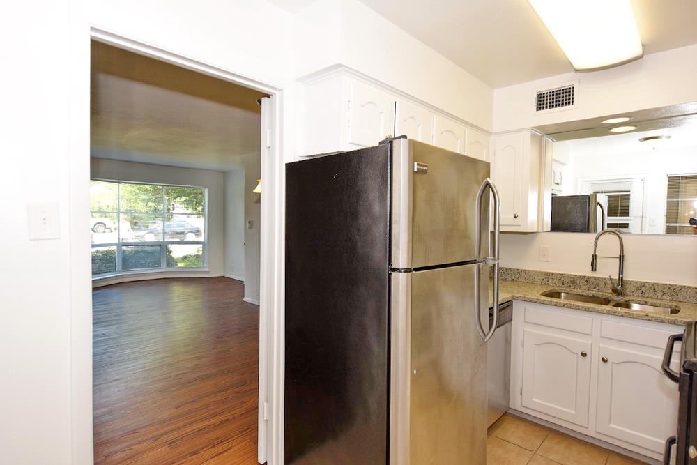 a white refrigerator freezer sitting inside of a kitchen