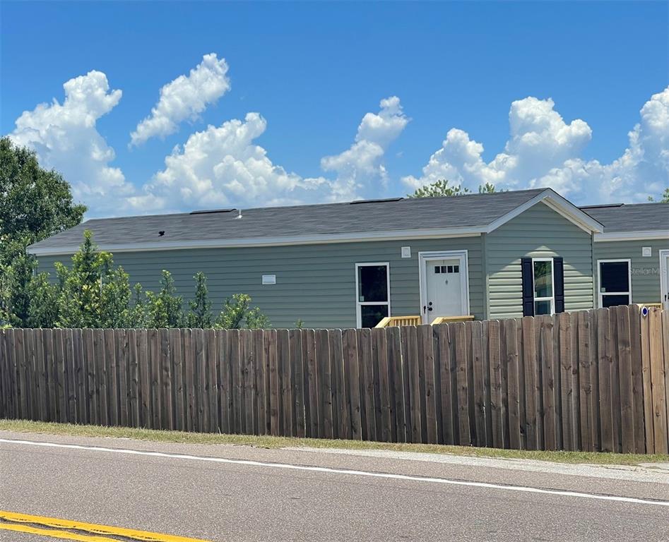 a view of a house with a backyard