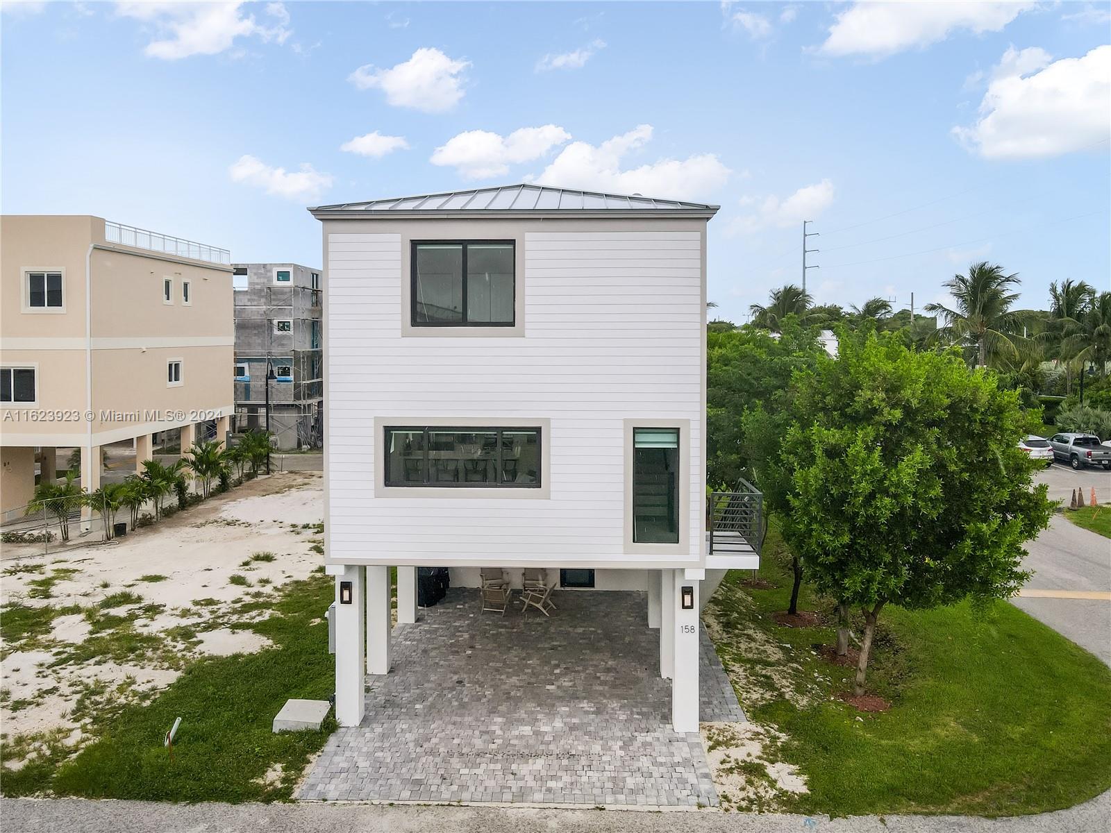 a view of a house with a yard and sitting area