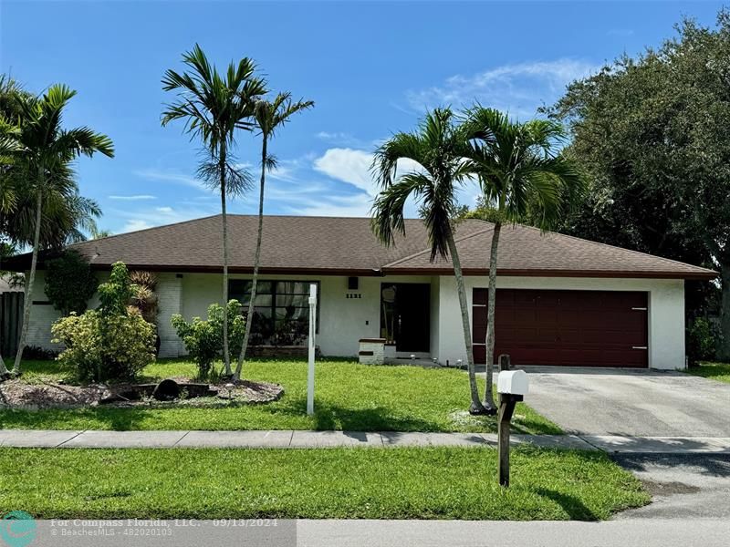 a front view of house with yard and green space