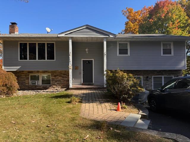 Bi-level home with a front lawn