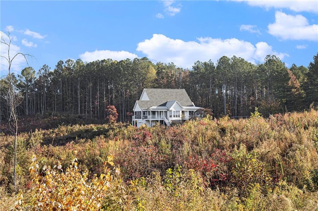 a view of a house with a yard and garden