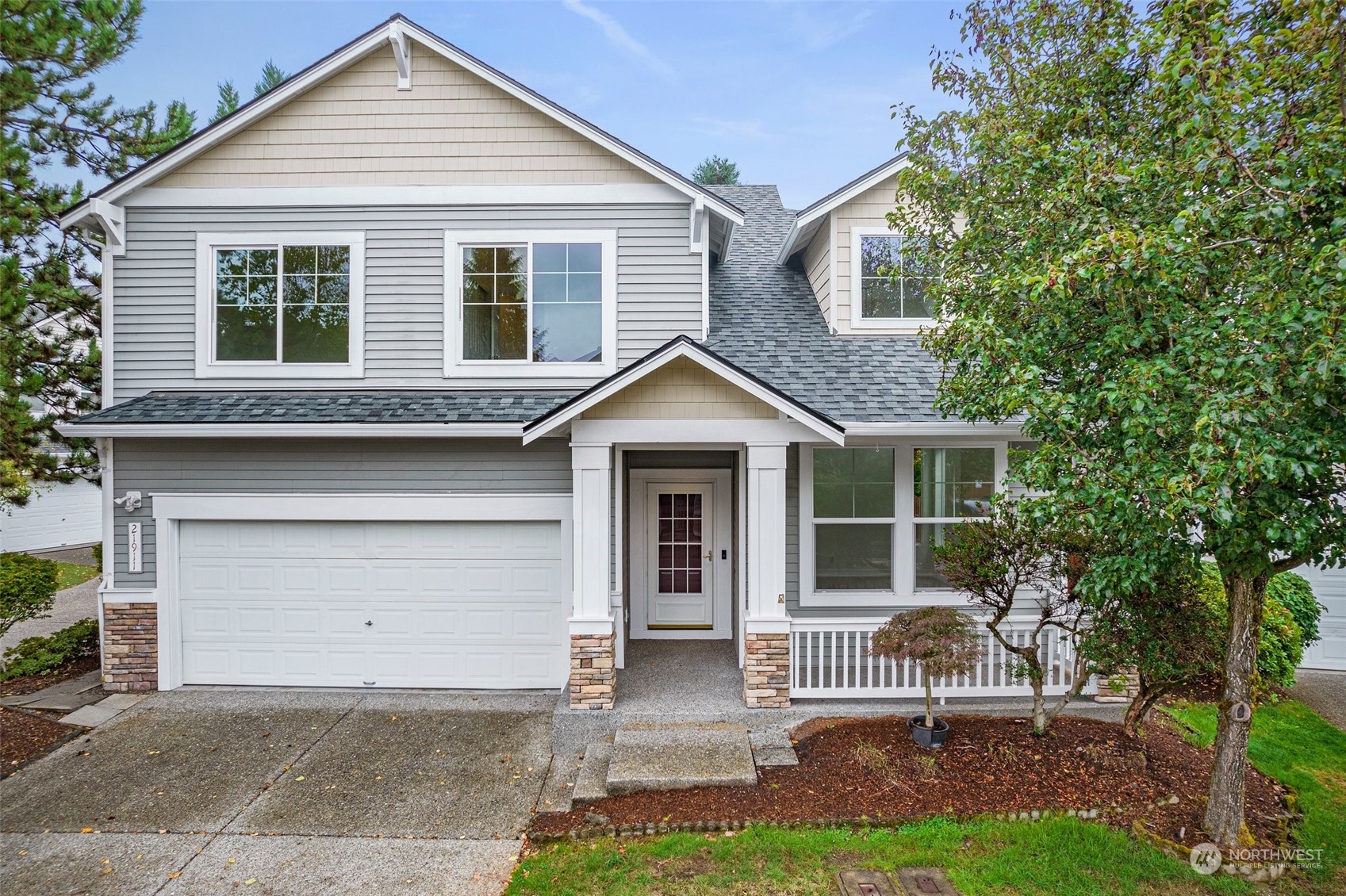 a front view of a house with a yard and garage