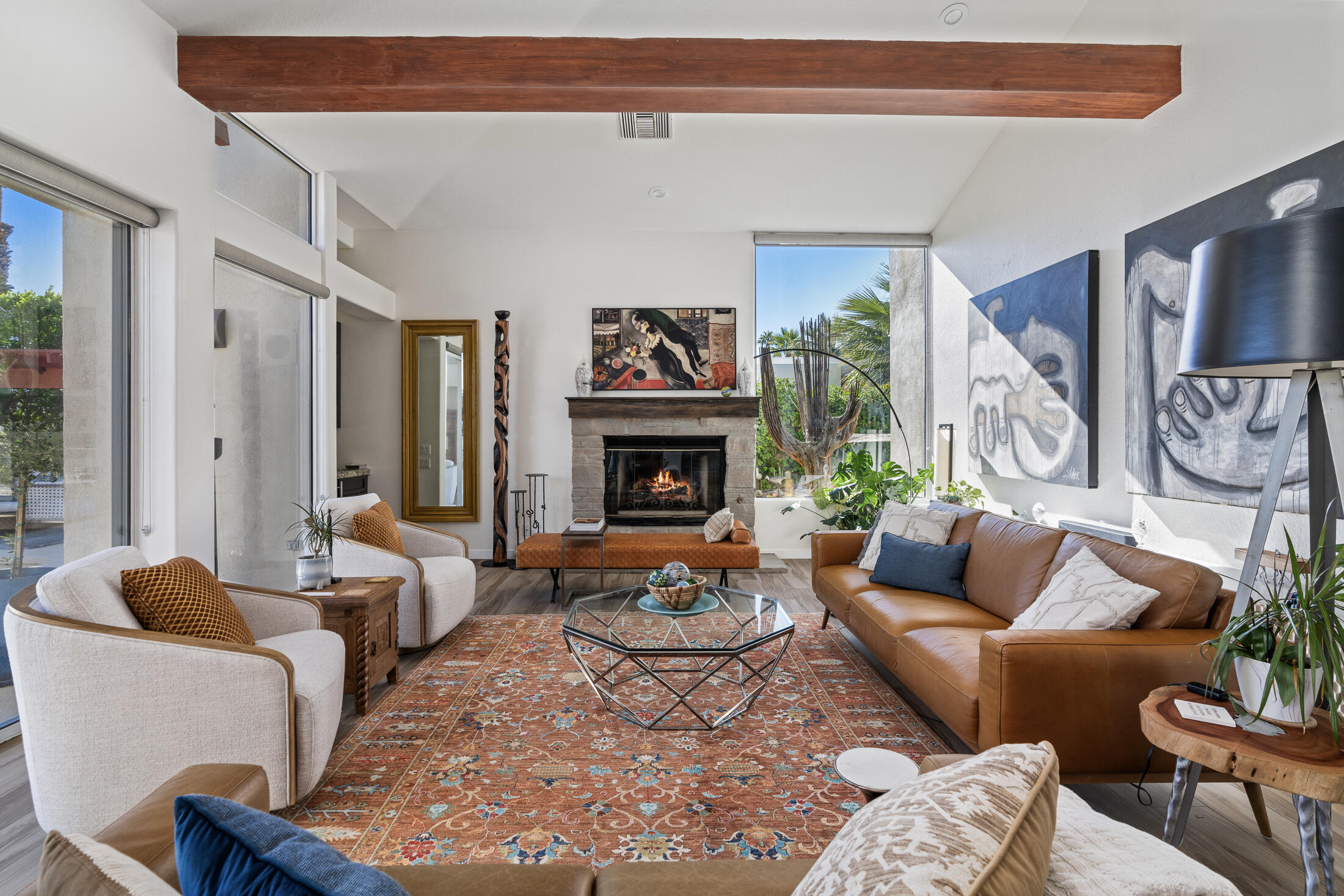 a living room with furniture a fireplace and a window