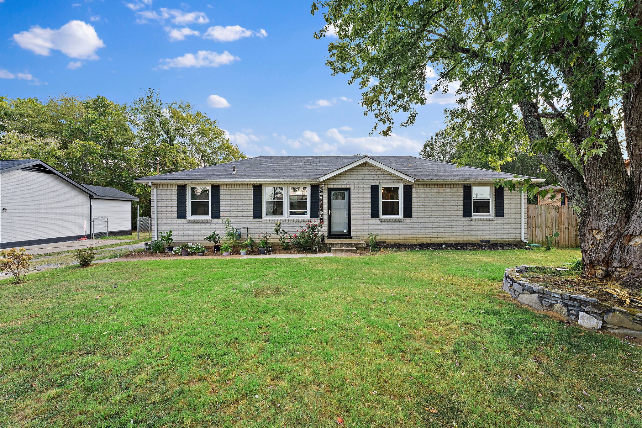 a front view of a house with a garden