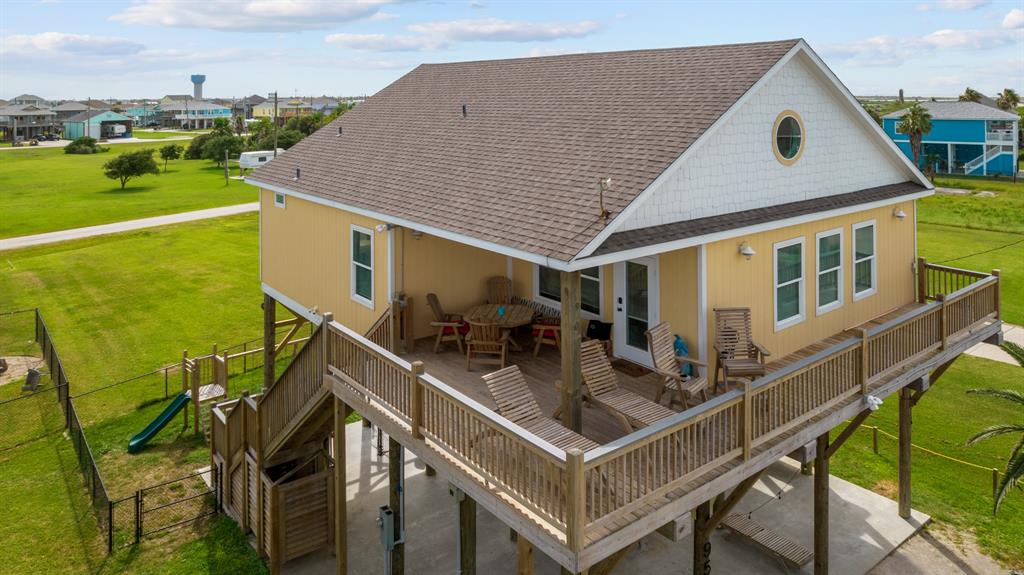 a view of a house with pool and chairs