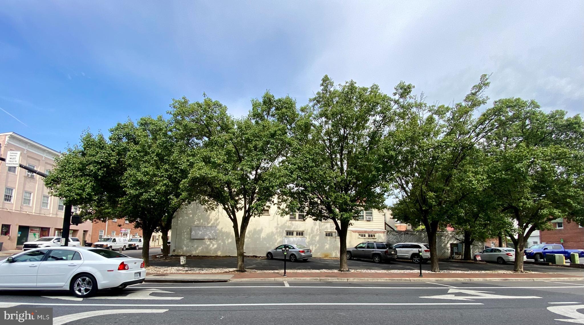 a view of a trees and cars on the side of a street