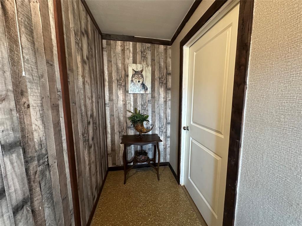 a view of a hallway and a livingroom with furniture