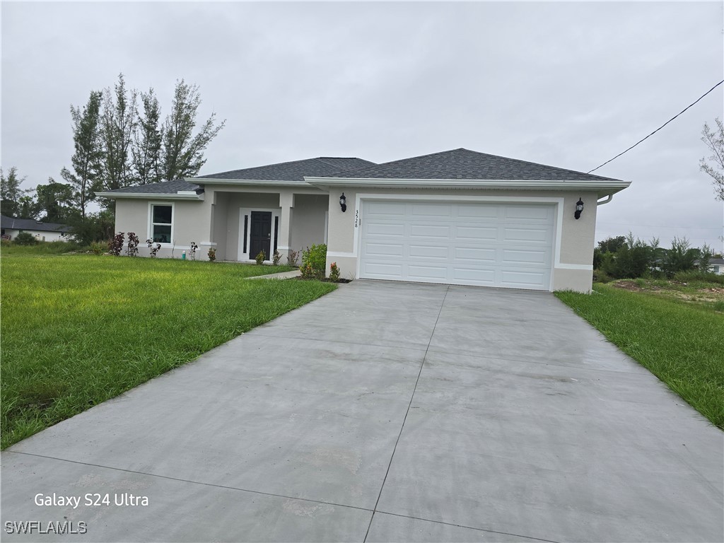 a front view of a house with yard and trees