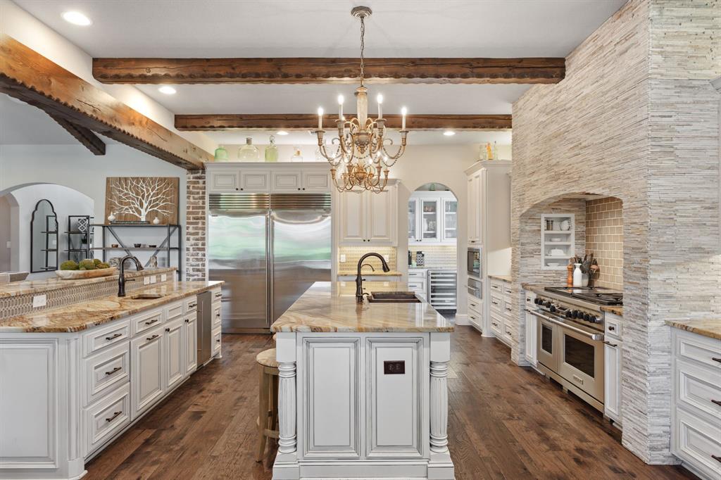 a kitchen with stainless steel appliances granite countertop a sink and stove