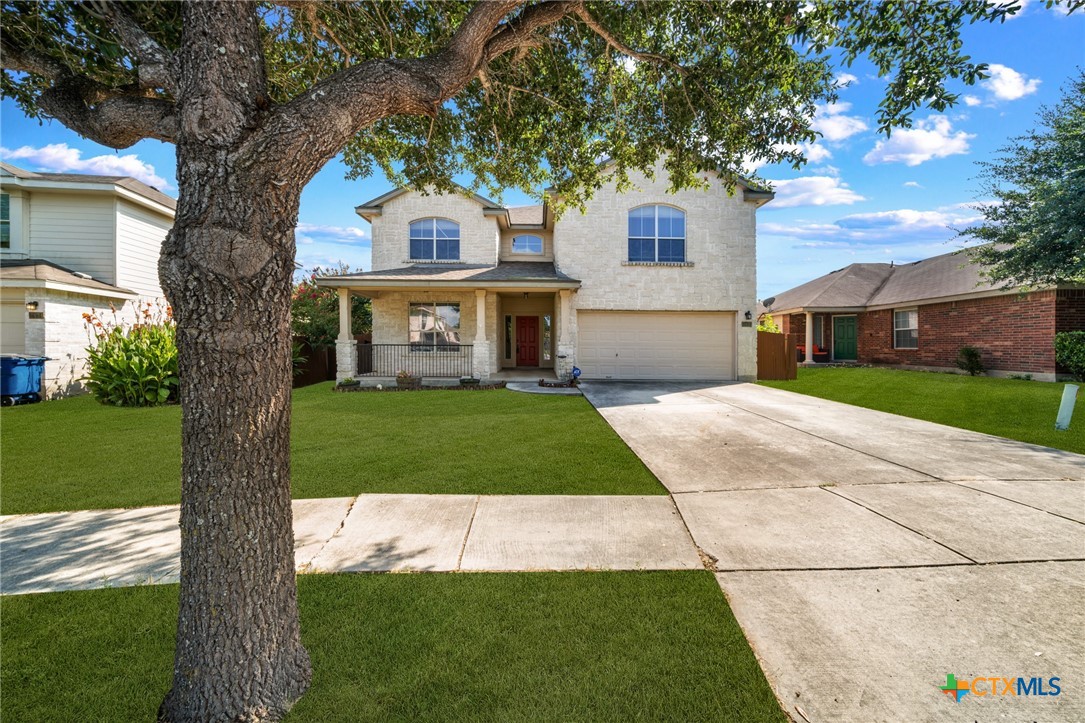 a front view of a house with a yard and garage