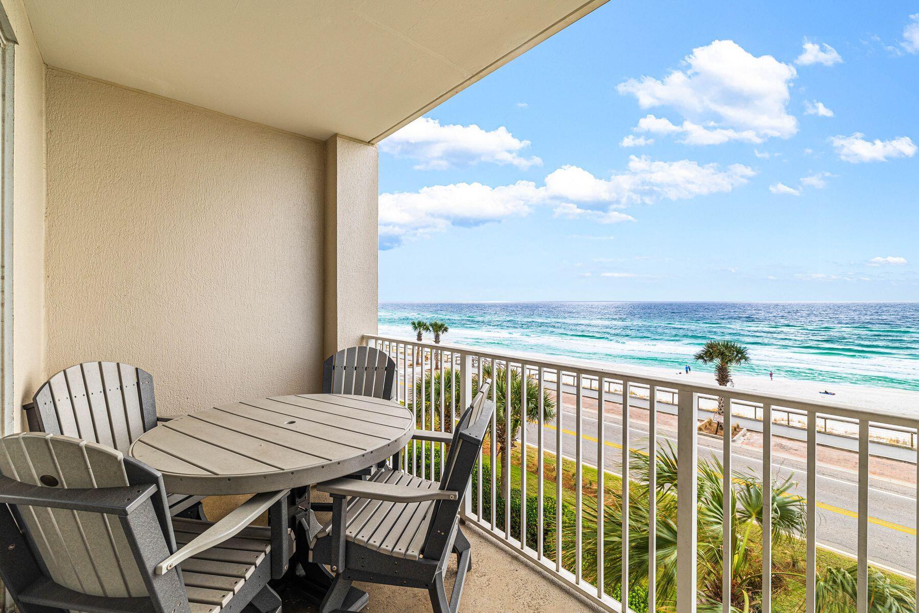 a view of a balcony with table and chairs