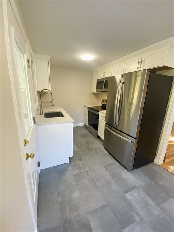 a refrigerator freezer sitting inside of a kitchen