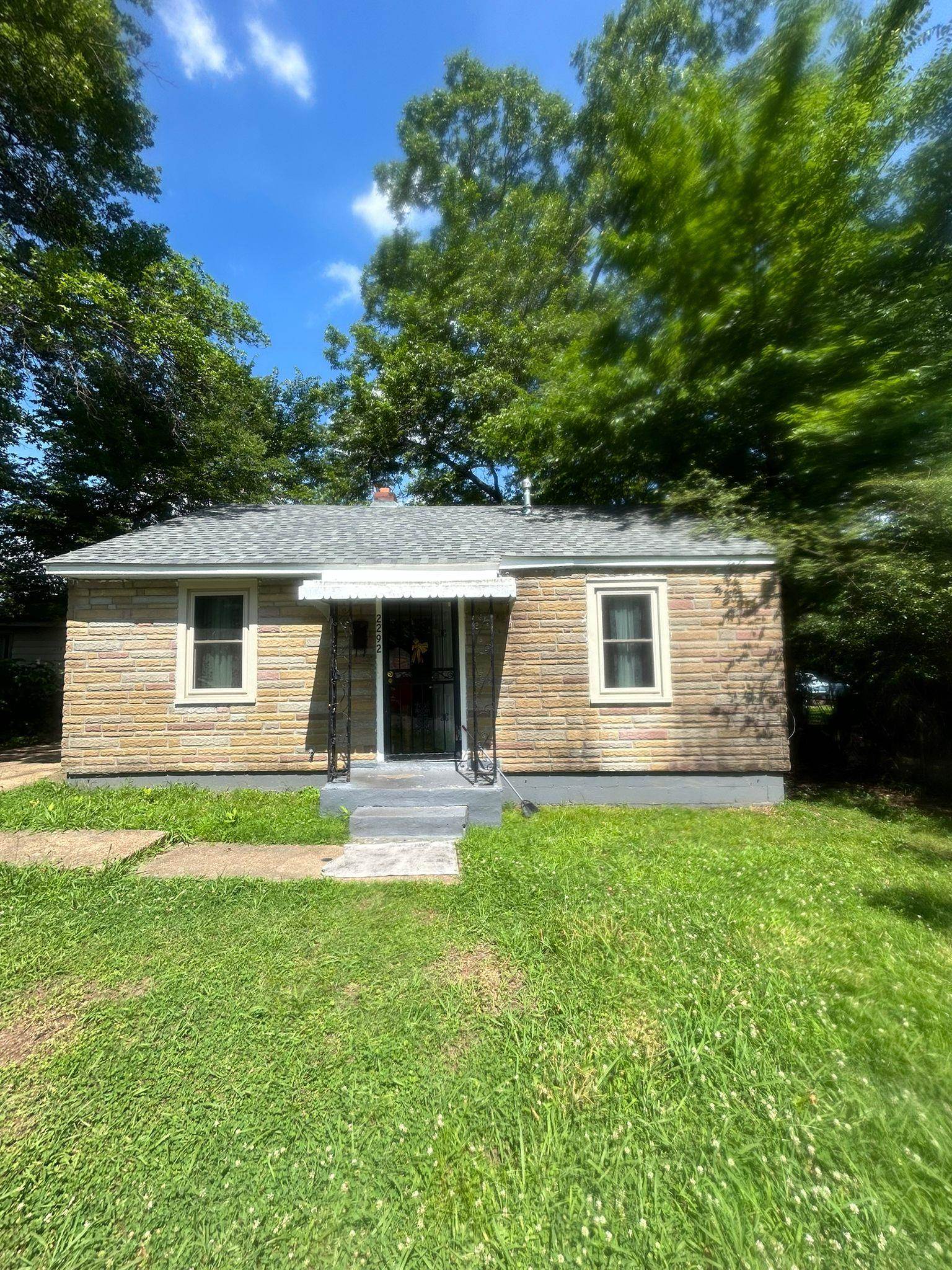 a front view of house with yard and green space