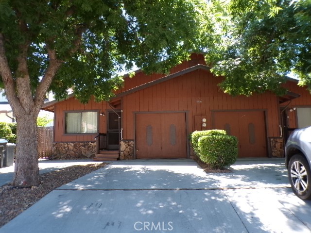 a front view of a house with a yard and a garage