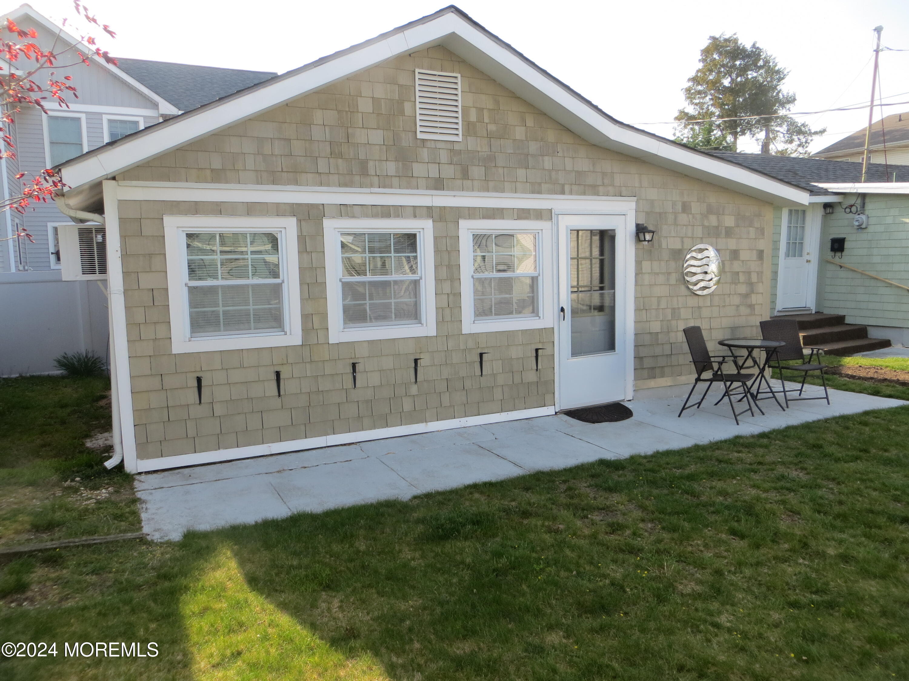 a front view of house with yard and outdoor seating