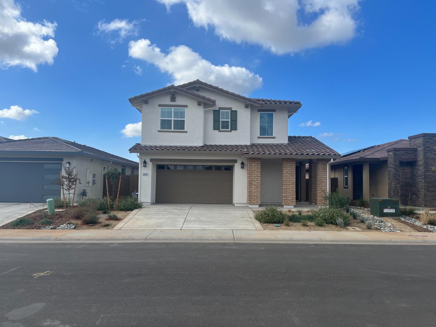 a front view of a house with yard