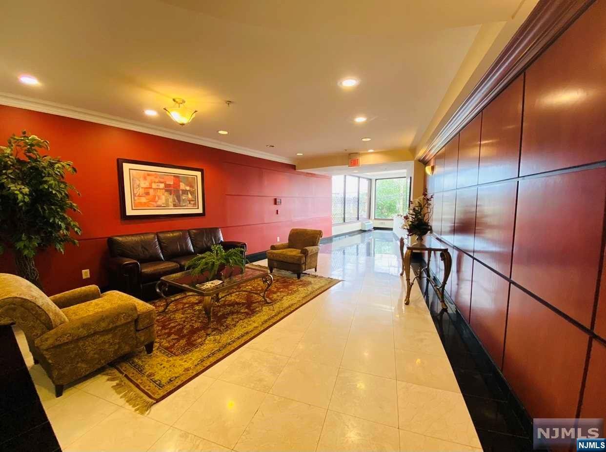 a living room with furniture pool table and a potted plant