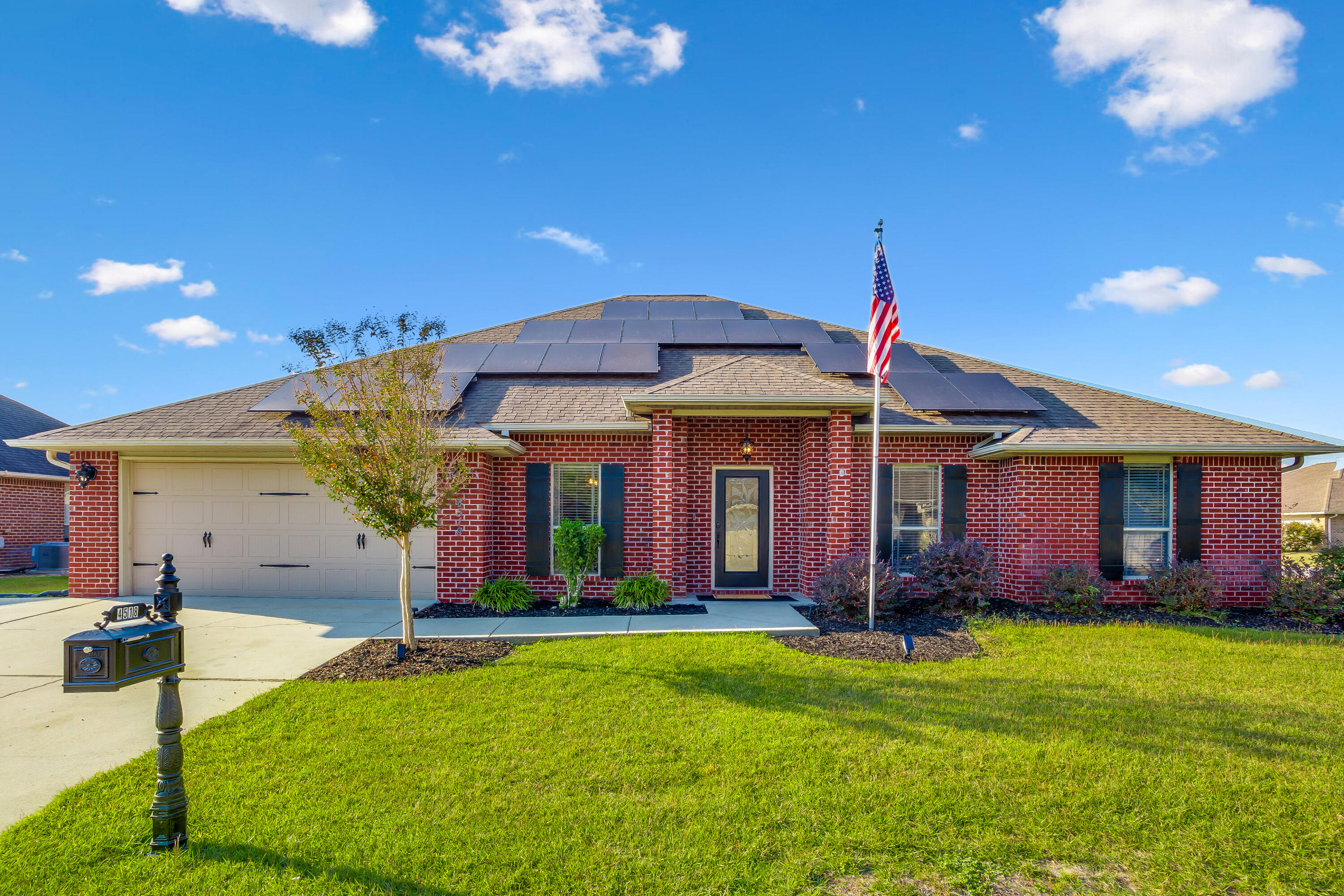 a front view of house with yard and outdoor seating