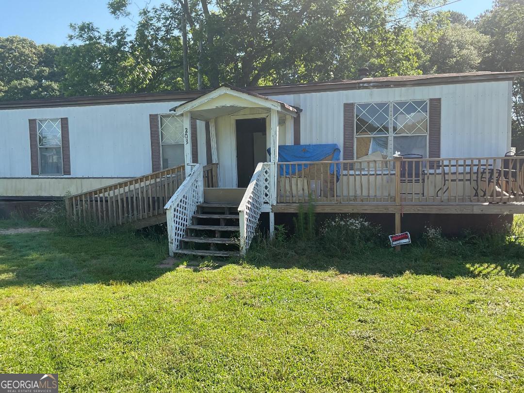 a view of a house with a yard and sitting area